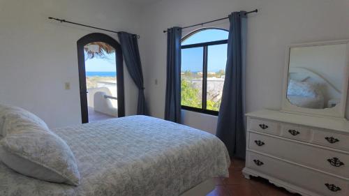 a bedroom with a bed and a dresser and a mirror at Ocean view casita in Palo Blanco in Los Barriles