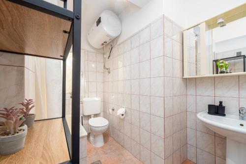 a bathroom with a toilet and a sink at Laguna Rooms in Pag