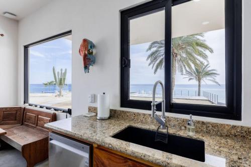 a kitchen with a sink and a view of the beach at Beachfront Pool, Rooftop Views & Baja Sunrise in Pescadero