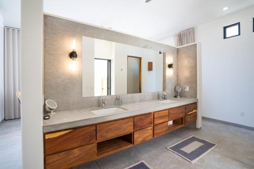 a bathroom with two sinks and a large mirror at Stunning Home with Incredible Views in Los Barriles