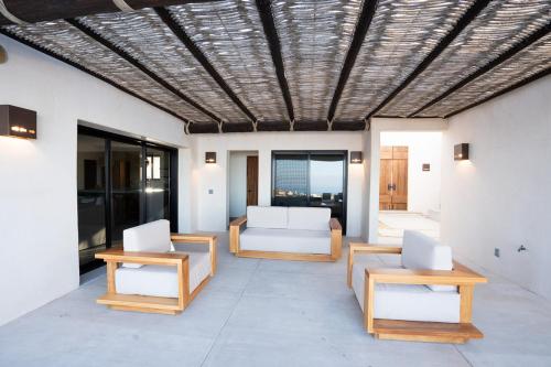 a living room with white chairs and a couch at Stunning Home with Incredible Views in Los Barriles