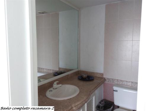 a bathroom with a sink and a mirror at Casa Horizonte Azul Acapulco in Acapulco
