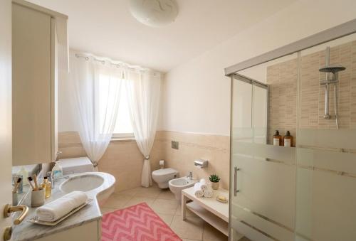 a white bathroom with a sink and a toilet at a casa di LUCA in Capriate San Gervasio