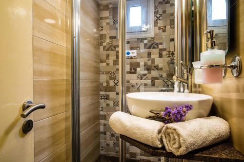 a bathroom with a sink and a shower at Semiramis Guesthouse in Adamas