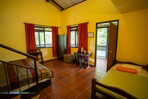 a bedroom with a bed and a desk in a room at Hotel Guaitipan Ancestral in San Agustín
