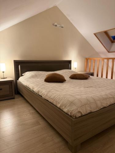 a bedroom with a bed with two pillows on it at Le 8 du Pontois in Ciney