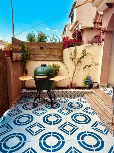 a grill on a tiled floor on a patio at Casa Midu Beachhouse 450m to the Beach in Los Alcázares