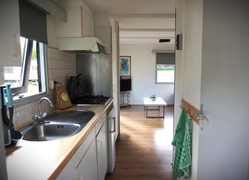 a kitchen with a sink and a counter top at 't Veldhuisje 109 - naast het bos, honden toegestaan in Anloo