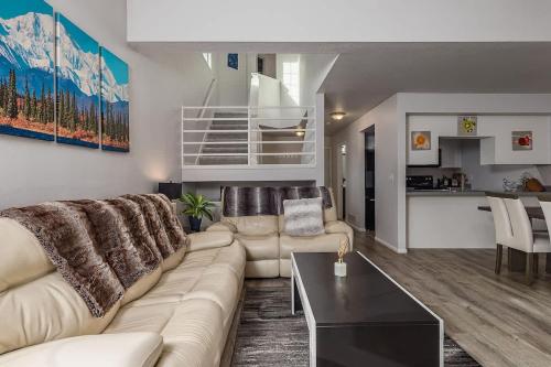 a living room with a couch and a table at Charming Luxe Home Sleeps 4 in Anchorage