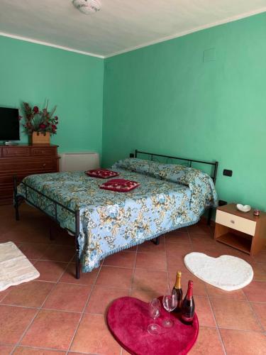 a bedroom with a bed and a table with wine glasses at Casa Lory in Posta Fibreno