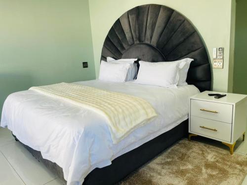 a bedroom with a large bed with a large headboard at Lifestyle Villas in Sipilini