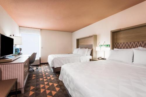 a hotel room with two beds and a flat screen tv at Holiday Inn - Boone - University Area by IHG in Boone
