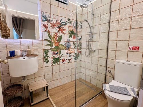 a bathroom with a shower and a toilet and a sink at Vicky's Panoramic View Apartments in Pelekas