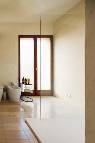 a bathroom with a glass shower door and a sink at Blu Rooms in Galatina