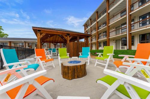 a group of colorful chairs and a table in front of a building at Serene Creek Condo Pool & Gym in Branson