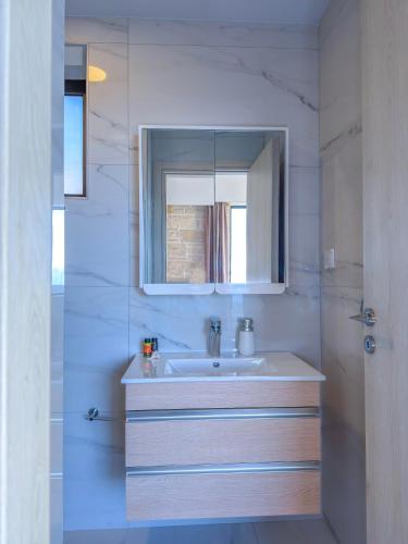 a bathroom with a sink and a mirror at Paleokastro Villas with Private Heated Pool, Top Views - Next To Center - Top WiFi in Kissamos