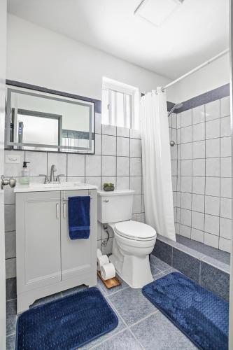 a bathroom with a toilet and a sink and a mirror at Slice of Paradise with Private Beach in Agat