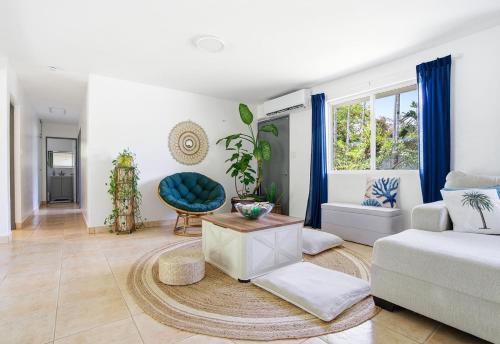 a living room with a couch and a table at Slice of Paradise with Private Beach in Agat