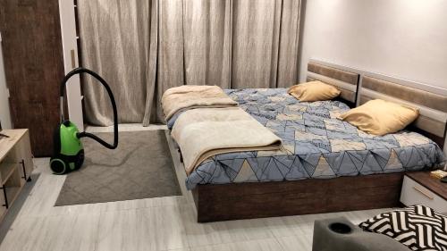 a bedroom with a bed and a vacuum at Avenue Alhambra princess resort in Hurghada