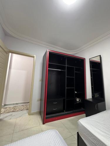 a bedroom with a large entertainment center with a tv at Spacious Apartment In 6 October in 6th Of October