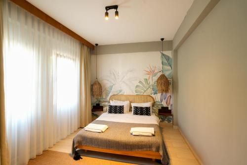 a bedroom with a bed and a painting on the wall at Alp Suites Mandalin in Akyaka