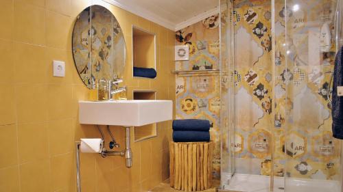 a bathroom with a sink and a shower at JC Seaside in Vila Franca do Campo