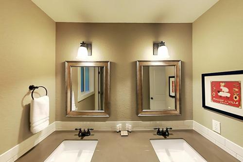 two sinks in a bathroom with two mirrors at Woodinville Escape in Woodinville