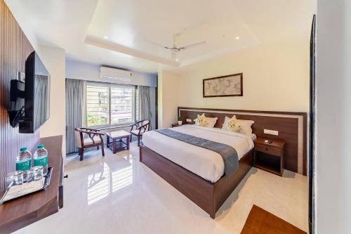 a hotel room with a bed and a table at Lumina Stays-Modern Luxury Rooms, Near NAD in Visakhapatnam