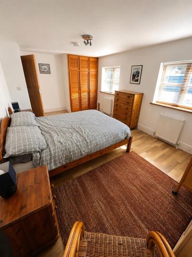 a bedroom with a large bed and a wooden floor at Maesbury Riverside in Oswestry