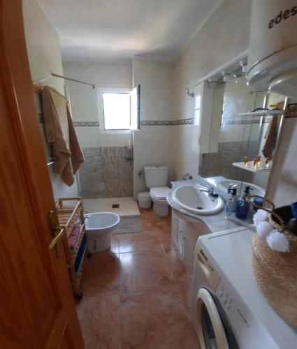 a bathroom with two sinks and two toilets at Casa Gaia in La Manga del Mar Menor