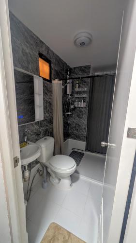 a bathroom with a toilet and a sink at City View Studio Pool - Gym - Caesar Residence in Mactan Island