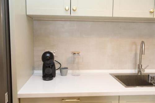 a kitchen counter with a black appliance on it at City Views Apartment in Shkodër