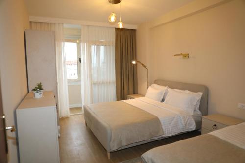 a hotel room with a bed and a window at City Views Apartment in Shkodër