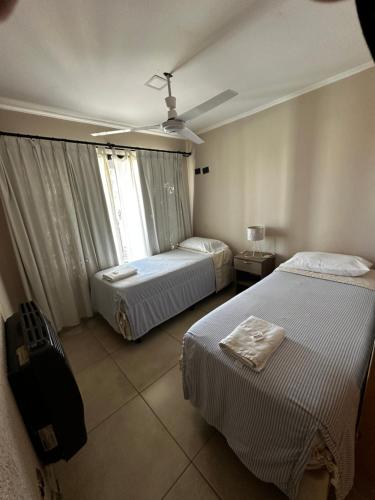 a hotel room with two beds and a window at Complejo Anjana in Federación