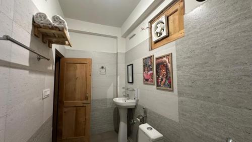 a bathroom with a sink and a toilet in it at Aroha Living in Bandal