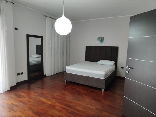 a bedroom with a bed and a mirror in it at Dimora C&A in Mondragone