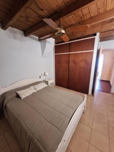 a bedroom with a bed and a ceiling fan at La Rocca in Colón