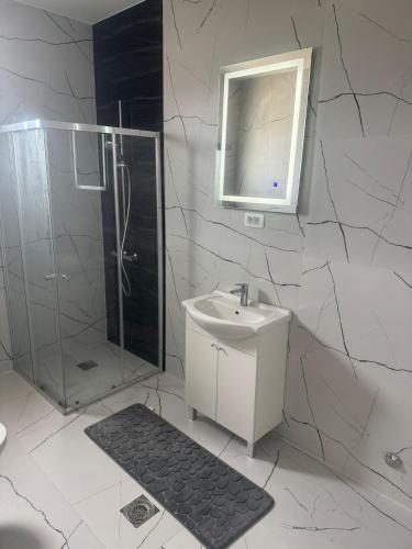 a white bathroom with a sink and a shower at Lux Villa Azur in Bar