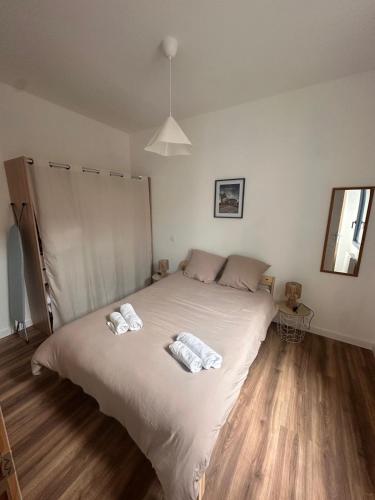 a bedroom with a large bed with two towels on it at Aquero Lourdes T2 in Lourdes