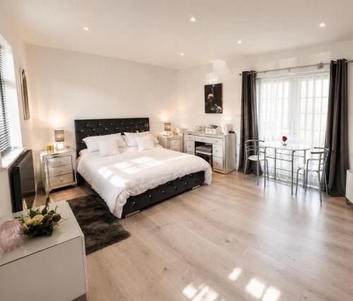 a bedroom with a bed and a table and chairs at The lodge in Rushbrooke