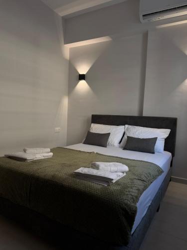 a bedroom with a bed with two towels on it at Lavandula in Xanthi