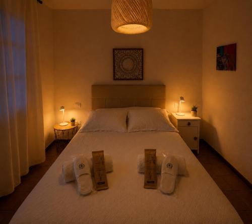 a bedroom with a large white bed with towels on it at Deluxe Mogán Beach Apt 2 in Puerto de Mogán