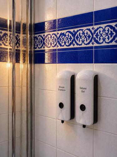 two rolls of toilet paper on a bathroom wall at Deluxe Mogán Beach Apt 2 in Puerto de Mogán