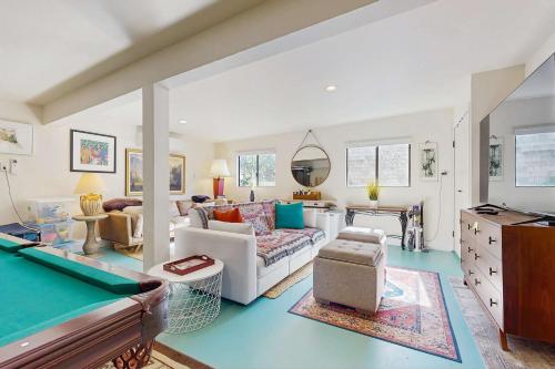 a living room with a couch and a pool table at Heron Escape in Bodega Bay