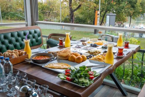 a table with food and drinks on a table with at River suite hotel in Manavgat