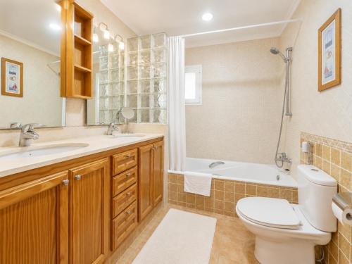 a bathroom with a toilet and a sink and a tub at Villa Maria Large Private Pool AC WiFi in Cala en Porter