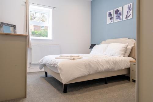 a bedroom with a bed and a window and a mirror at 2 BR Apartment- Private Parking in Newport
