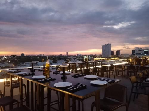 a table on a roof with a view of the city at Mesón de la Luna Hotel & Spa in Mérida