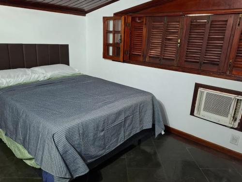 a bedroom with a bed and a window and a fan at Casa da Jabuticaba! in Itatiaia