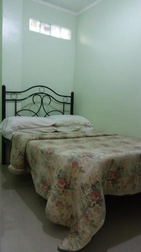 a bedroom with a bed with a blanket on it at Dweller's Pensione in Iloilo City